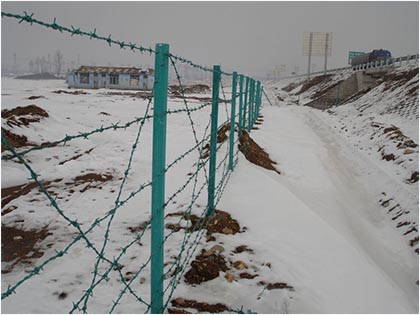 Barbed wire fencing installed on both sides of the road