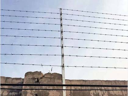 Barbed wire installed at the top of the wall