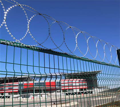 Flat razor wire mounted on top of the fence
