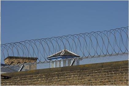 Concertina razor barbed wire mounted on top of walls